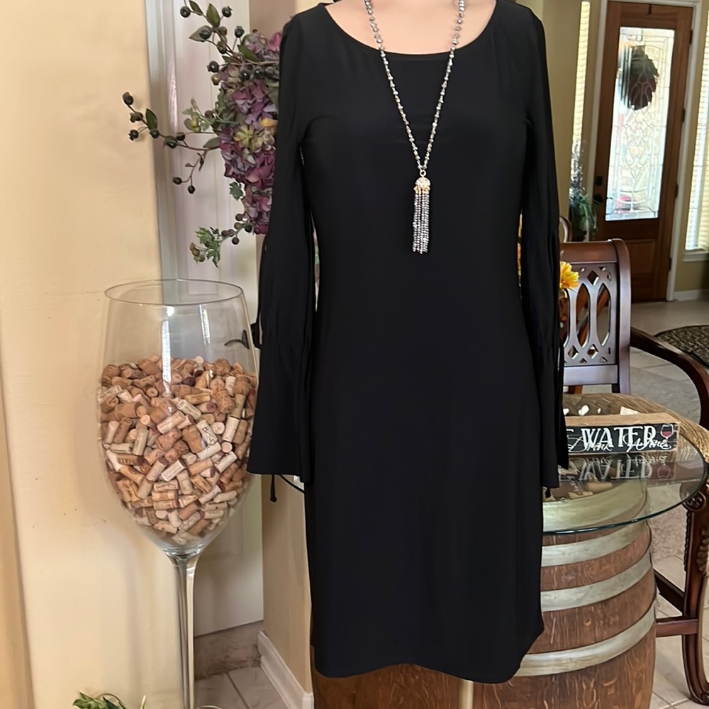 White House Black market stretch to fit black dress with cut outs on sleeves